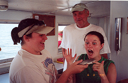 Ricki Morrison and Meadowlark Kastner examine a shark pup a little too close