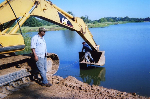 James Essex watches the extension being placed on the drain pipe
