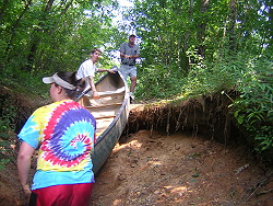 Pushing the canoe up the ditch