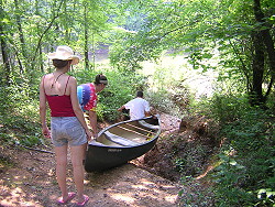 Sliding the canoe down the ditch