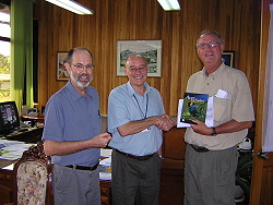 Dr. Pedro Ferreira and CATIE Board of Directors President, Dr.  Richard Rortvedt, present Thomas Wilson with a copy of Bird of the Highlands. 