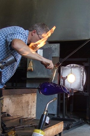 Cal Breed shaping a cobalt vase; image by Caroline Price