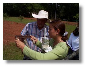 Mr. Amling instructs Melanie Longwell in use of the draw knife