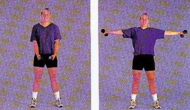 A woman demonstrating how to perform the lateral raise exercise. 