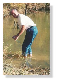 Dr. Thomas Wilson samples the water of Clear Creek